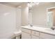 Bright bathroom featuring double vanity sinks, quartz countertops, and a tiled tub-shower combination at 6646 Merrimack Dr, Castle Pines, CO 80108