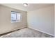 Clean and simple carpeted bedroom with a window allowing natural light at 6646 Merrimack Dr, Castle Pines, CO 80108