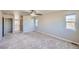 Bedroom with large windows, neutral colored paint, carpet flooring, and ceiling fan at 6646 Merrimack Dr, Castle Pines, CO 80108