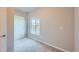 Bedroom featuring neutral carpet, a window with blinds, and a white door at 6646 Merrimack Dr, Castle Pines, CO 80108