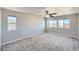 Spacious bedroom featuring neutral paint, plush carpet, and large windows for ample natural light at 6646 Merrimack Dr, Castle Pines, CO 80108