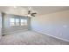 Neutral bedroom featuring carpet, ceiling fan, and large windows with views at 6646 Merrimack Dr, Castle Pines, CO 80108