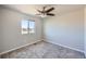 Neutral bedroom featuring carpet, ceiling fan, and a window with neighborhood views at 6646 Merrimack Dr, Castle Pines, CO 80108