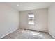 Neutral bedroom with gray carpet, small window, and neutral wall color at 6646 Merrimack Dr, Castle Pines, CO 80108