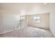 Spacious bonus room or loft space with neutral carpet, windows, and staircase with white railing at 6646 Merrimack Dr, Castle Pines, CO 80108