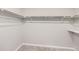 Interior view of an empty walk-in closet featuring a shelf and clothes rack at 6646 Merrimack Dr, Castle Pines, CO 80108