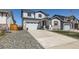 Lovely two-story home with two-car garage, a well-kept lawn, and stone veneer accents at 6646 Merrimack Dr, Castle Pines, CO 80108