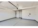 Spacious garage featuring painted floor and walls, overhead lighting, and room for storage at 6646 Merrimack Dr, Castle Pines, CO 80108