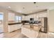 Well-equipped kitchen with a center island, stainless steel appliances, wood flooring and pendant lights at 6646 Merrimack Dr, Castle Pines, CO 80108