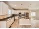 Modern kitchen featuring white cabinetry, stainless steel appliances, wood floors, and a center island at 6646 Merrimack Dr, Castle Pines, CO 80108