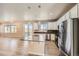 Spacious kitchen with a center island, stainless steel appliances, wood flooring and modern light fixtures at 6646 Merrimack Dr, Castle Pines, CO 80108