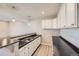 Basement kitchenette area featuring modern cabinetry, countertops, and stainless steel sink at 6646 Merrimack Dr, Castle Pines, CO 80108
