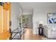 Inviting entryway with light gray walls, hardwood floors, and a glimpse into the dining area at 4182 W Quinn Pl, Denver, CO 80236