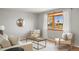 Bright living room featuring a bay window, neutral walls, and stylish furnishings at 4182 W Quinn Pl, Denver, CO 80236