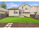 Well-maintained backyard featuring a lush green lawn and a charming patio area, perfect for outdoor relaxation at 21052 E 45Th Ave, Denver, CO 80249