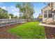 Well-maintained backyard featuring artificial turf, a wooden fence, and mulch, offering a private outdoor space at 21052 E 45Th Ave, Denver, CO 80249