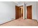 Carpeted bedroom with several interior doors, providing access to adjacent rooms, offering potential layout options at 21052 E 45Th Ave, Denver, CO 80249