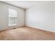 Simple bedroom with neutral carpet and a window that provides natural light, creating a serene atmosphere at 21052 E 45Th Ave, Denver, CO 80249