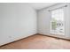 Bedroom featuring a neutral carpet, a window, and light-colored walls, offering a blank canvas for personalization at 21052 E 45Th Ave, Denver, CO 80249