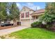 Charming two-story home with a well-manicured lawn, two car garage, and lovely curb appeal at 21052 E 45Th Ave, Denver, CO 80249