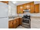 Functional kitchen with wooden cabinets, stainless steel appliances, and ample countertop space at 21052 E 45Th Ave, Denver, CO 80249