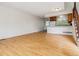 Spacious living room with hardwood floors, open floor plan, and breakfast bar with kitchen access at 21052 E 45Th Ave, Denver, CO 80249