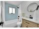 Updated bathroom featuring a tub, blue tile accent wall, and modern vanity at 1173 Xenon St, Golden, CO 80401