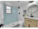 Updated bathroom featuring a walk-in shower, accent wall, and modern vanity at 1173 Xenon St, Golden, CO 80401