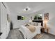 Bright bedroom with neutral decor, two windows, carpet, and modern furnishings at 1173 Xenon St, Golden, CO 80401