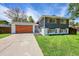 Inviting home with modern garage door, fresh exterior paint, and lush green lawn at 1173 Xenon St, Golden, CO 80401