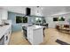 Bright open concept showing the kitchen island, dining area, and living room, promoting a functional gathering space at 1173 Xenon St, Golden, CO 80401