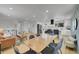 Open layout showcasing the kitchen, dining area, and living space with a modern aesthetic and natural light at 1173 Xenon St, Golden, CO 80401