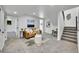 Cozy living room with carpeted floors, modern furniture, and access to stairs at 1173 Xenon St, Golden, CO 80401