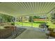 Covered patio with outdoor seating and a view of the lush backyard at 1173 Xenon St, Golden, CO 80401