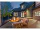 Backyard features an outdoor fireplace and seating area for entertaining on a stone patio at 11406 Conifer Ridge Dr, Conifer, CO 80433