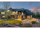 Beautiful backyard with patio, rock accents, lush lawn, and elegant home exterior at 11406 Conifer Ridge Dr, Conifer, CO 80433