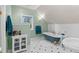 Elegant bathroom featuring a clawfoot tub, white wainscoting, and a bright window at 11406 Conifer Ridge Dr, Conifer, CO 80433