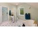 Bright bathroom with white cabinetry, a soaking tub with gold hardware, and tiled walk-in shower at 11406 Conifer Ridge Dr, Conifer, CO 80433