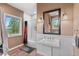 Bathroom featuring a pedestal sink, large mirror, decorative lights, and wood-look floors at 11406 Conifer Ridge Dr, Conifer, CO 80433