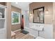 Bathroom featuring a pedestal sink, wainscoting, and a shower with great views at 11406 Conifer Ridge Dr, Conifer, CO 80433