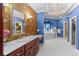 Luxurious primary bathroom with elegant gold fixtures, a jetted tub, and lots of storage space at 11406 Conifer Ridge Dr, Conifer, CO 80433