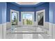 A soaking tub in an alcove with bright natural light and mountain views at 11406 Conifer Ridge Dr, Conifer, CO 80433