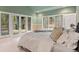 Well lit bedroom with large windows and french doors leading to balcony overlooking nature at 11406 Conifer Ridge Dr, Conifer, CO 80433