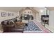 Bonus room with a music studio, leather sectional, plush rug, and natural light at 11406 Conifer Ridge Dr, Conifer, CO 80433