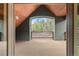 Covered wood deck overlooking the beautiful forested outdoors, accessible through large sliding glass door at 11406 Conifer Ridge Dr, Conifer, CO 80433