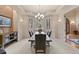 Dining room features a large table, chandelier, and backyard views at 11406 Conifer Ridge Dr, Conifer, CO 80433
