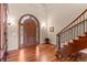 Beautiful wood floors accent this entryway with a decorative door and stairway at 11406 Conifer Ridge Dr, Conifer, CO 80433