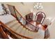 Elegant foyer with a curved staircase, chandelier, and hardwood floors at 11406 Conifer Ridge Dr, Conifer, CO 80433