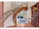 Grand foyer with a sweeping staircase and hardwood floors creates a stunning entrance at 11406 Conifer Ridge Dr, Conifer, CO 80433
