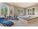 Hot tub room featuring natural light, blue lounge chairs, and views of the backyard at 11406 Conifer Ridge Dr, Conifer, CO 80433
